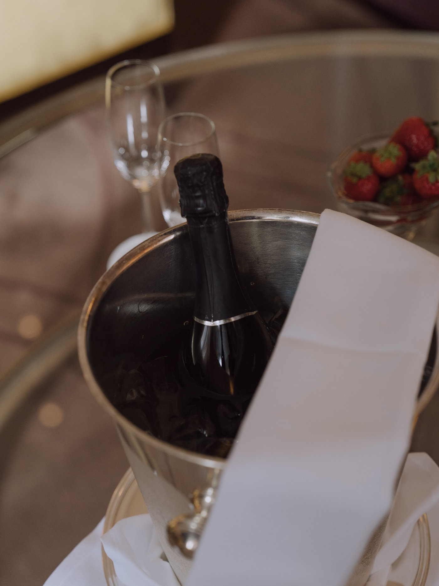 Champagne bucket with strawberries in a hotel room